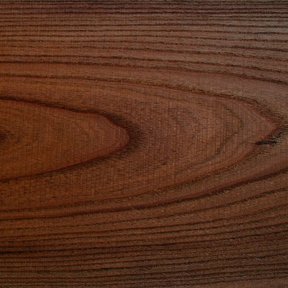 Veta de la madera de paraíso, de color castaño y anillos ondulados.