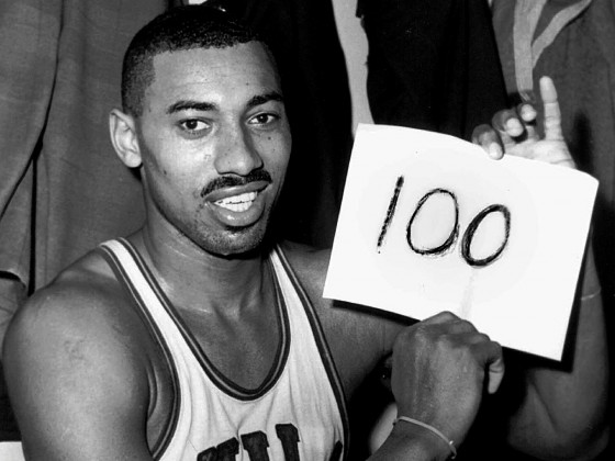 ADVANCE FOR WEEKEND OF MARCH 2-3--Philadelphia Warriors' Wilt Chamberlain holds a sign reading "100" in the dressing room in Hershey, Pa., after he scored a record 100 points as the Warriors defeated the New York Knickerbockers 169-147, in this March 2, 1962 photo. Chamberlain died in October 1999 at age 63. (AP Photo/Paul Vathis, file)