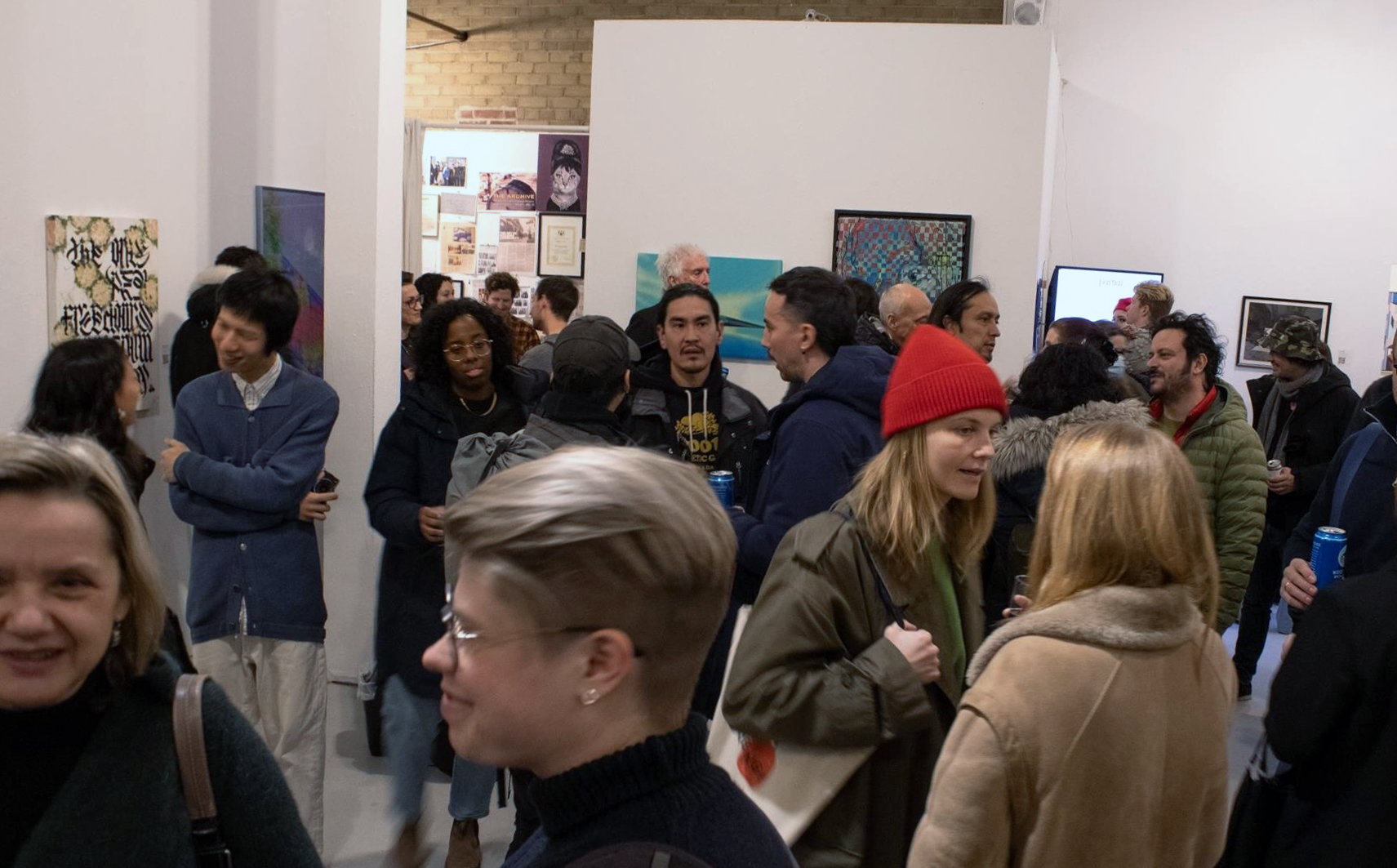 Visitors walking through a gallery exhibition